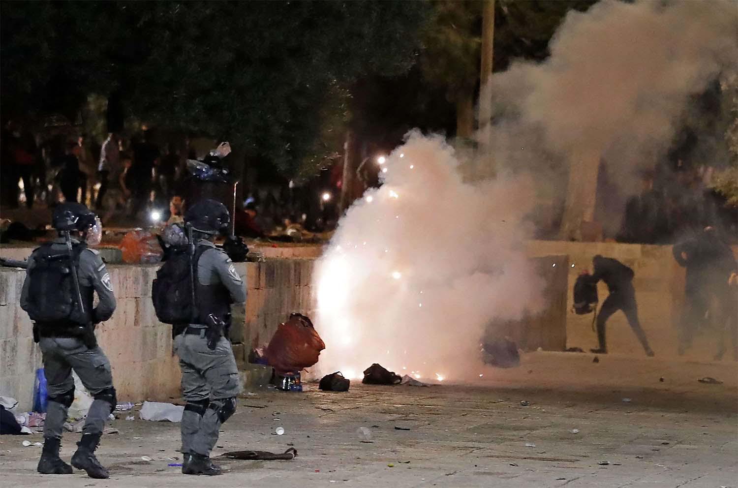 Tear gas billows amid clashes between Israeli security forces and Palestinian protesters at the al-Aqsa mosque compound