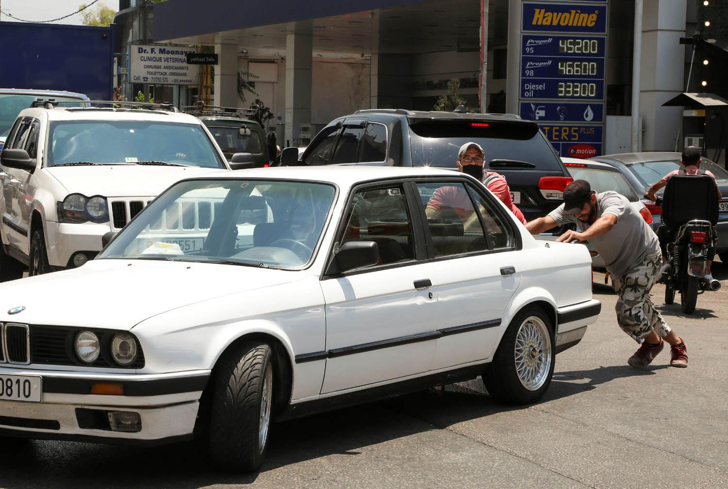 لبناني يدفع بسيارته أمام محطة وقود في بيروت