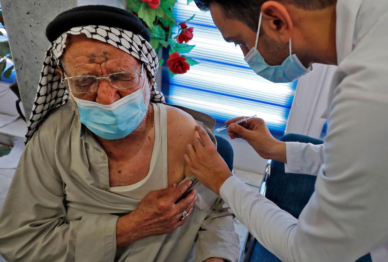 مسن عراقي يتلقى تلقيح ضد كوفيد
