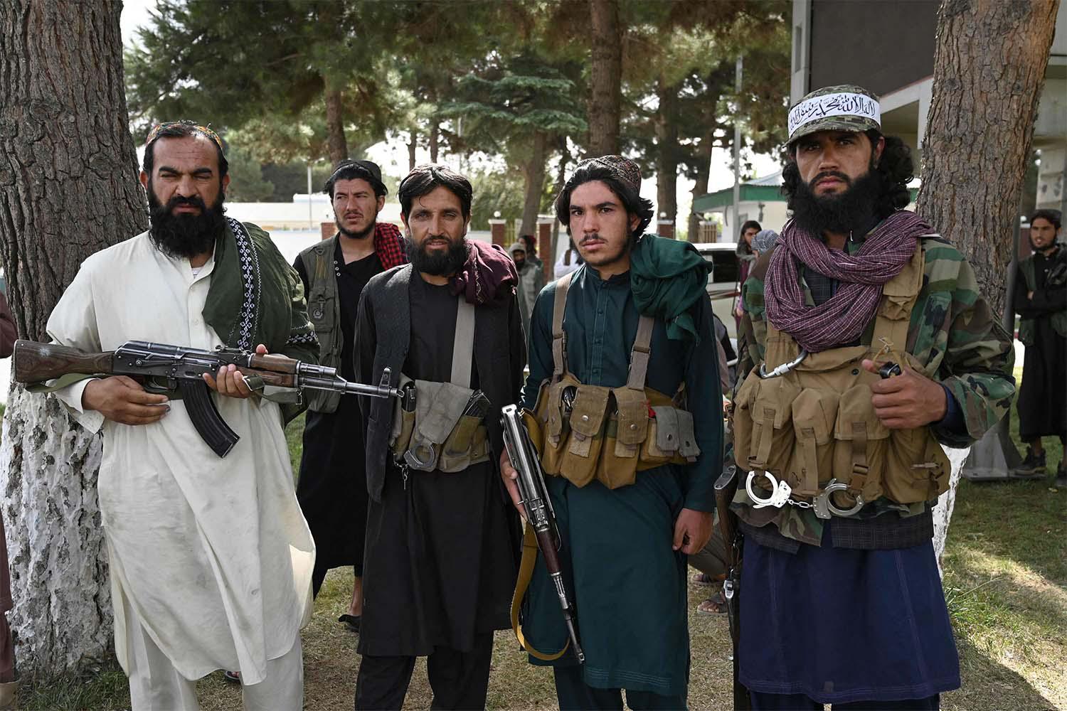 Taliban fighters stand guard inside the airport in Kabul after US troop pullout