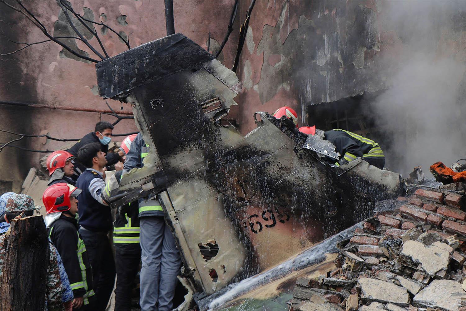 Debris from the crashed fighter jet is seen in Tabriz