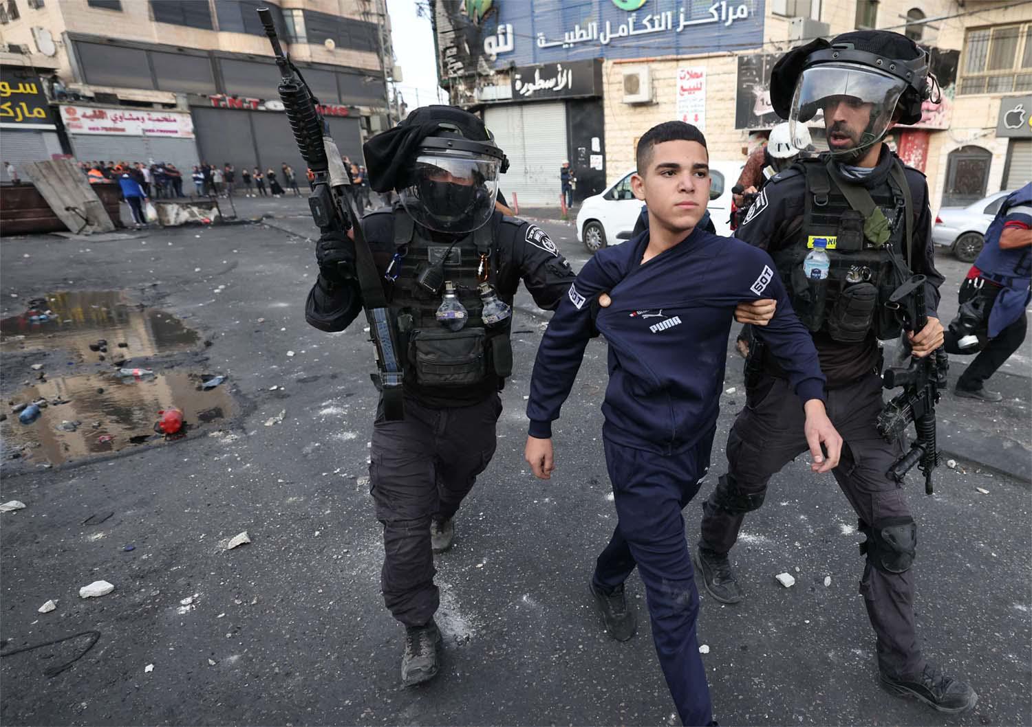 Israeli soldiers in confrontation with Palestinian protesters at the refugee camp