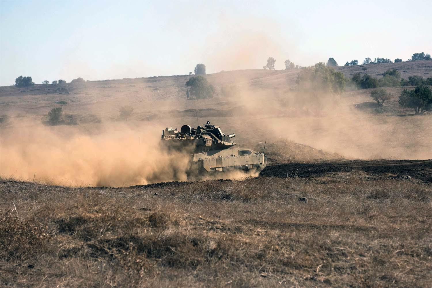 An Israeli tank moves to a position during a drill in the annexed Golan Heights