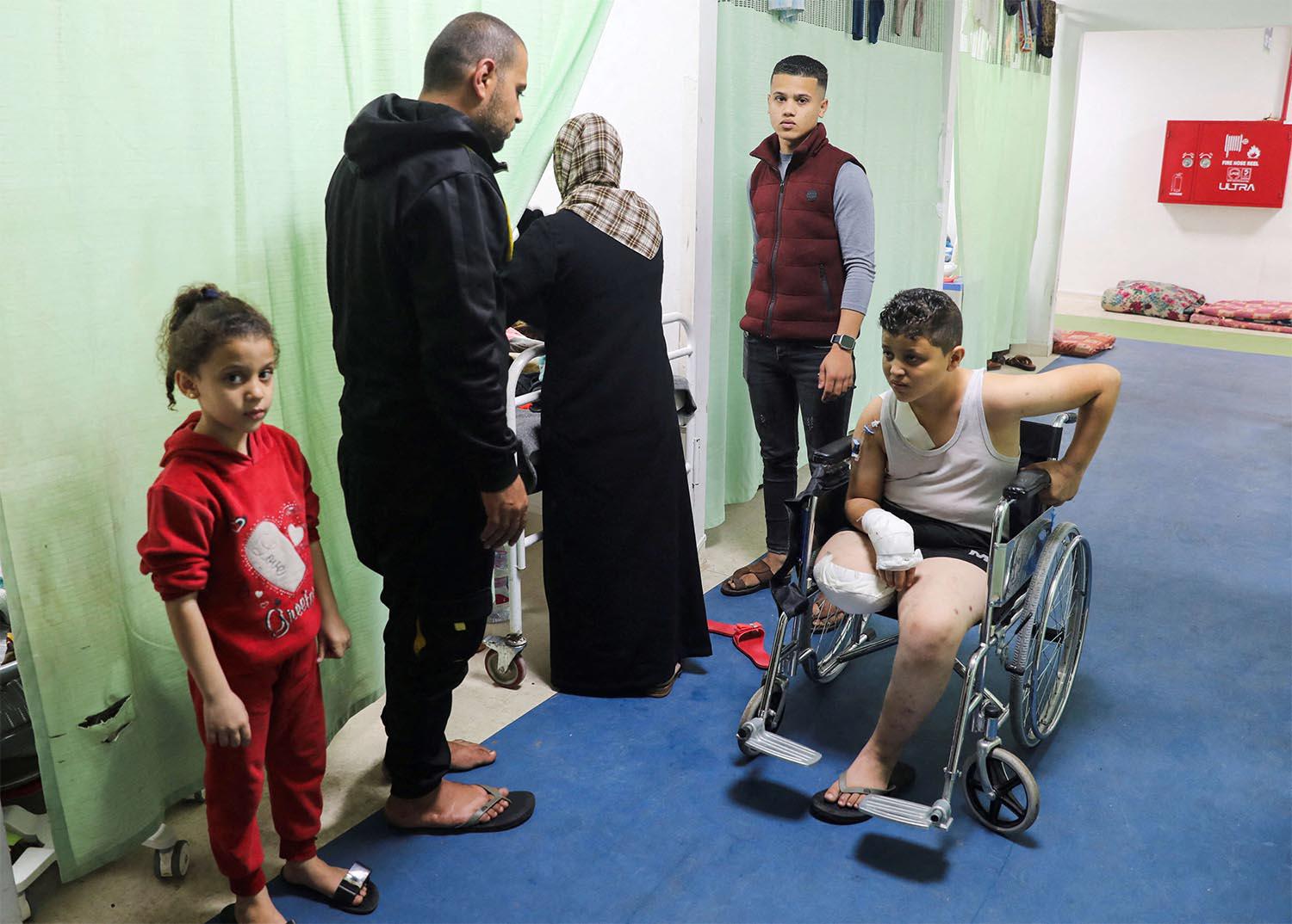 A Palestinian teenager whose limb was amputated after being wounded in an Israeli strike