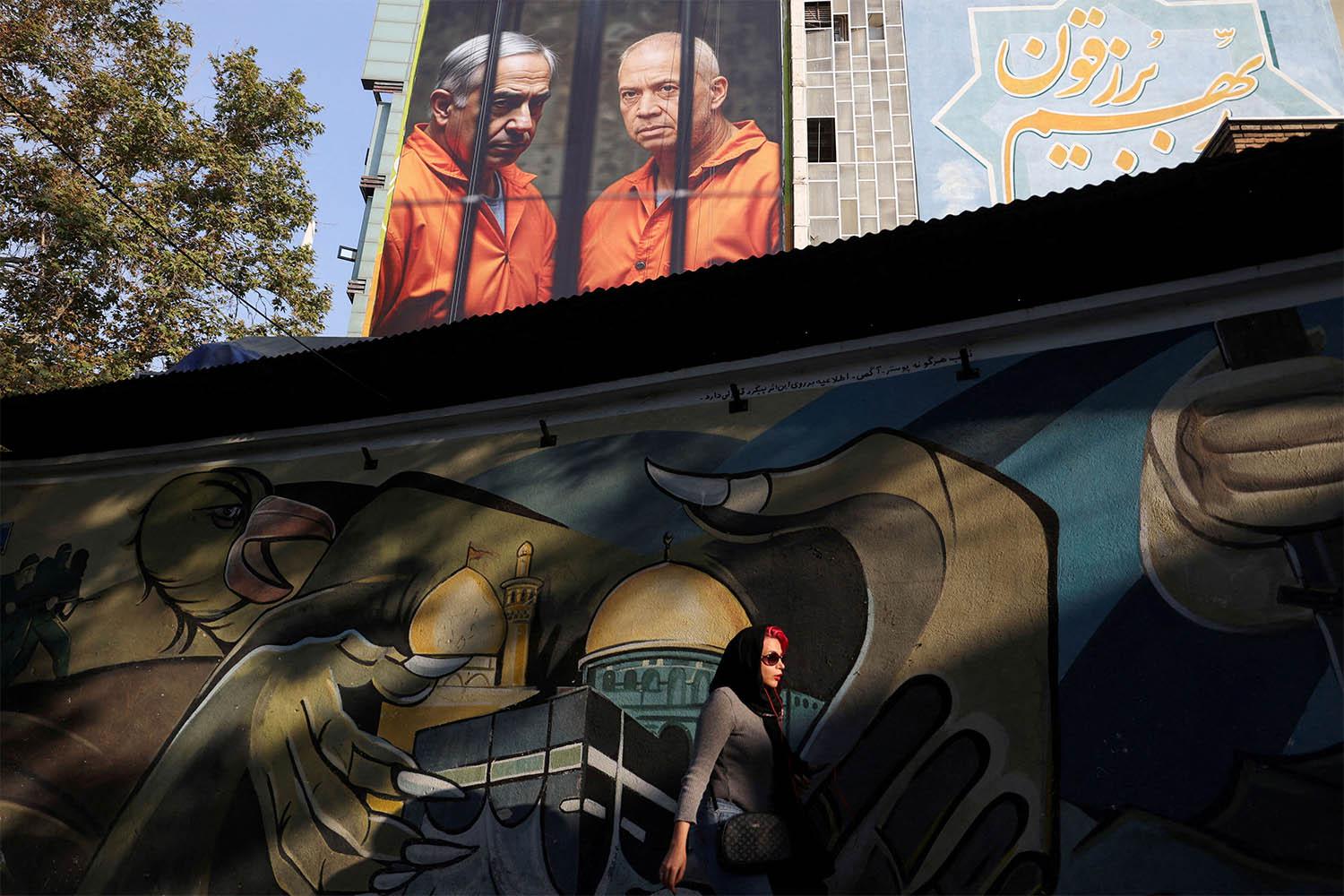 A picture of Israel's PM Benjamin Netanyahu and former Defense Minister Yoav Gallant is displayed on a building in Tehran