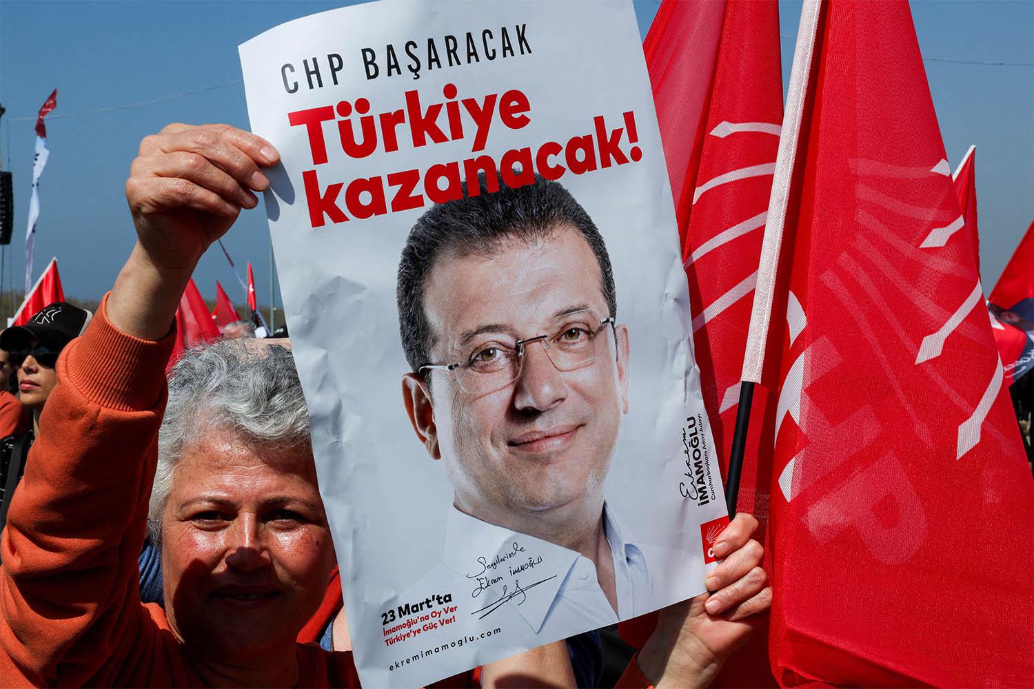 A person holds a placard during a rally to protest against the arrest of Istanbul Mayor Ekrem Imamoglu