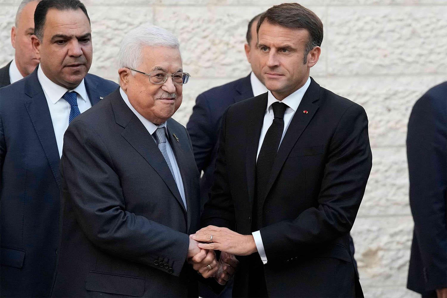 Macron shaking hands with Abbas