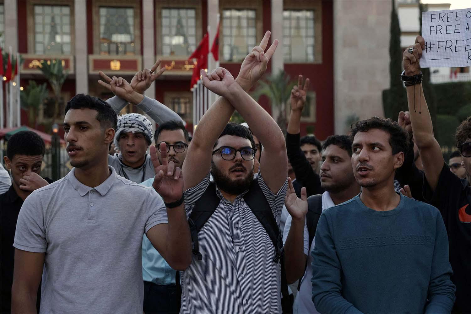 Demonstrators gesture during a youth-led protest demanding reforms to public healthcare and education in front the Parliament in Rabat