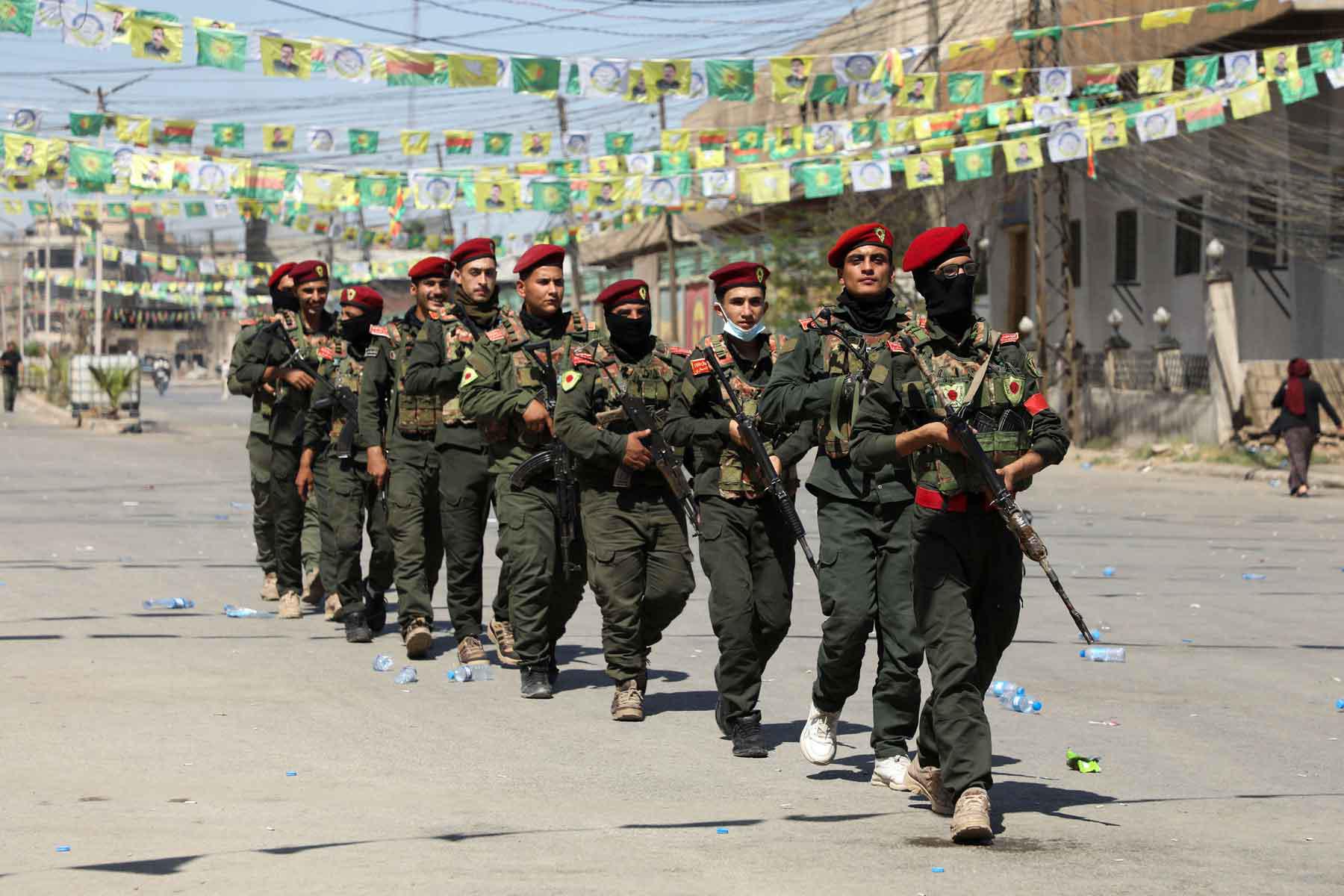 Armed members of the Syrian Democratic Forces (SDF) military police take part in a demonstration under the banner “With our will, we will protect our revolution,” in Qamishli, Syria, September 17, 2025. 