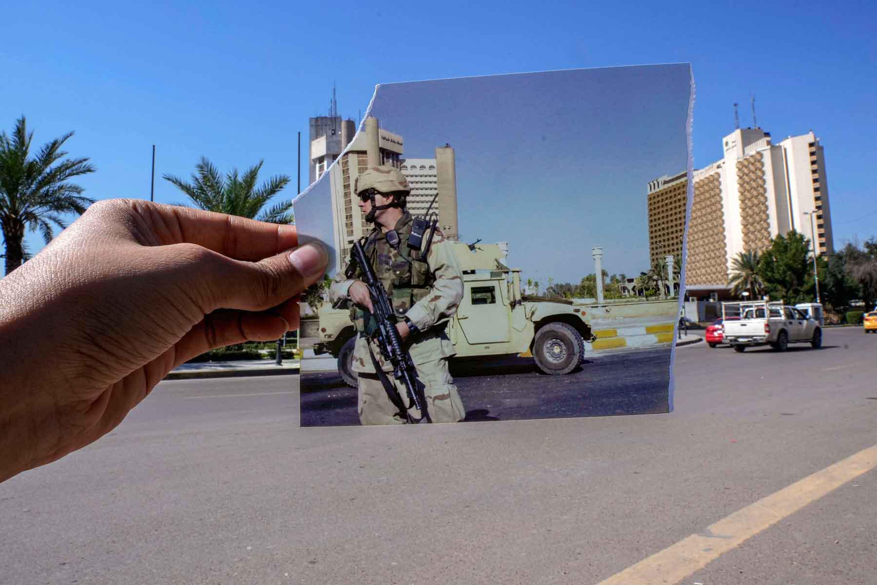 A photograph of a US soldier standing guard in Firdous square in front of the Sheraton (L) and Palestine hotels after they came under attack, July 2, 2004 is inserted into the scene at the same location, March 10, 2023.