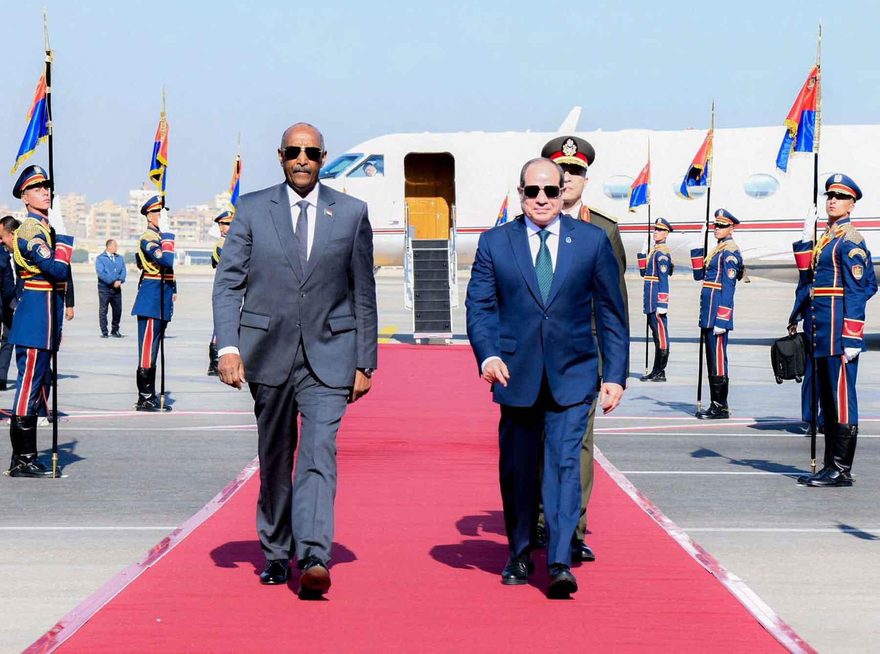 Egyptian President Abdel Fattah al-Sisi welcomes with army chief Abdel Fattah al-Burhan at Cairo International Airport, December 18, 2025. 