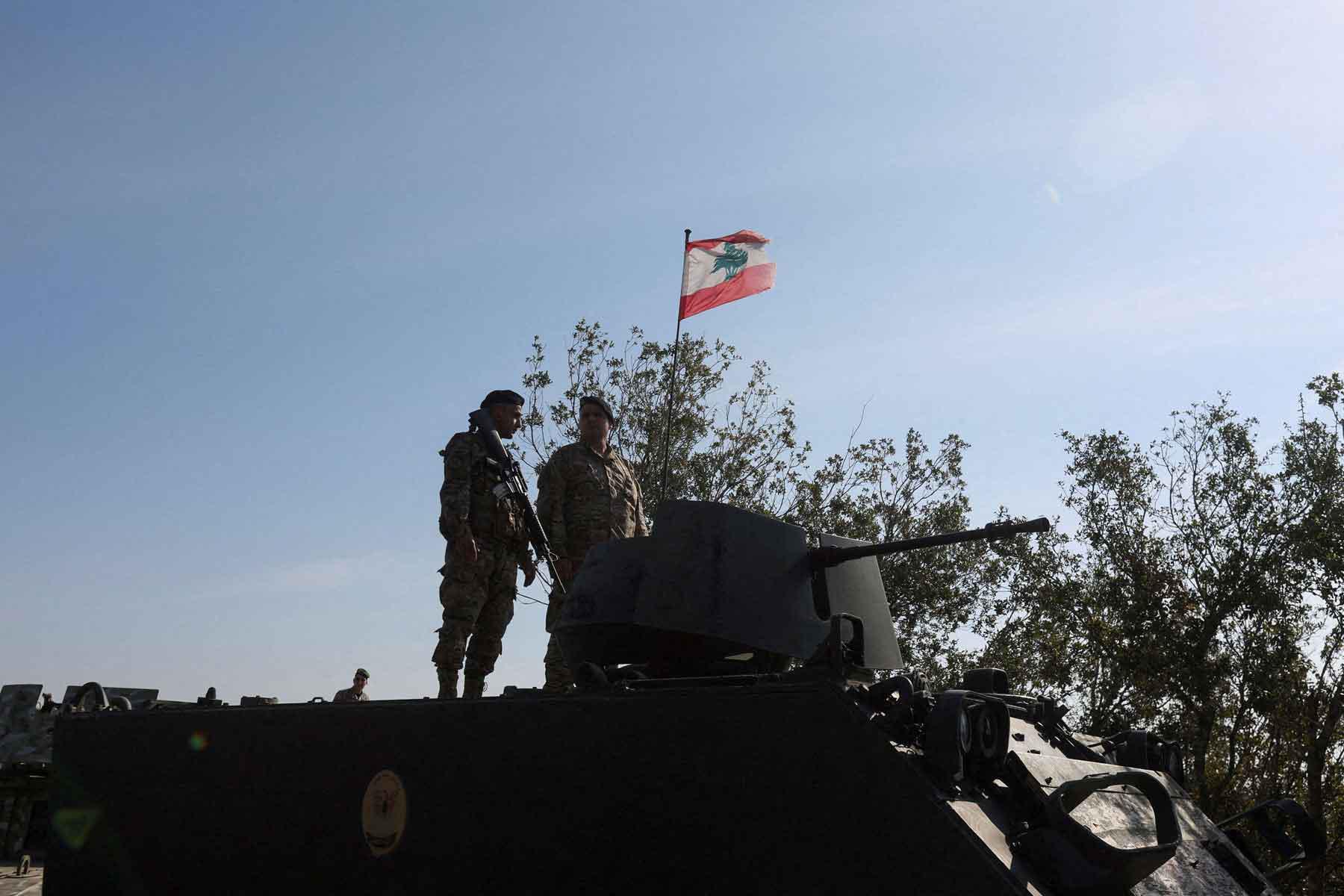 Lebanese army members stand on a military vehicle in the southern Litani sector, in Alma Al-Shaab, near the border with Israel, southern Lebanon, November 28, 2025. 