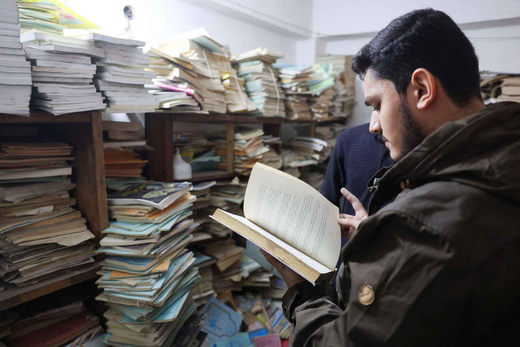 A customer reads a book inside a basement dedicated to books near Al-Mutanabbi Street in Baghdad.
