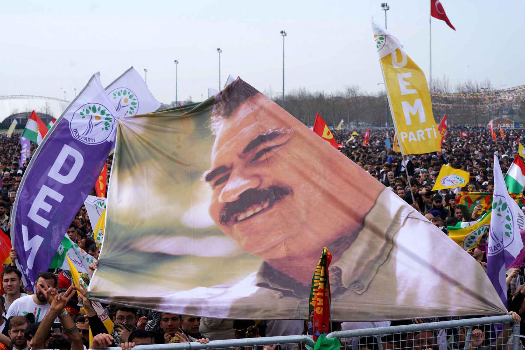 Supporters of the pro-Kurdish Peoples Equality and Democracy Party (DEM Party) hold a banner with an image of jailed Kurdish militant leader Abdullah Ocalan during a gathering in Istanbul, March 23, 2025. 