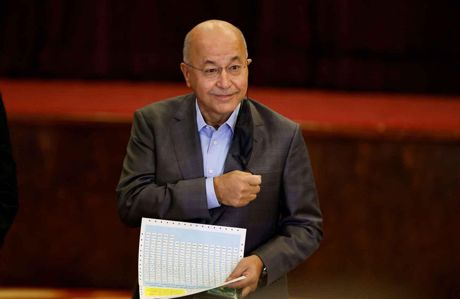 Iraq’s former president Barham Salih casts his vote at a polling station in Baghdad, as Iraqis go to the polls to vote in the parliamentary election, October 10, 2021. 