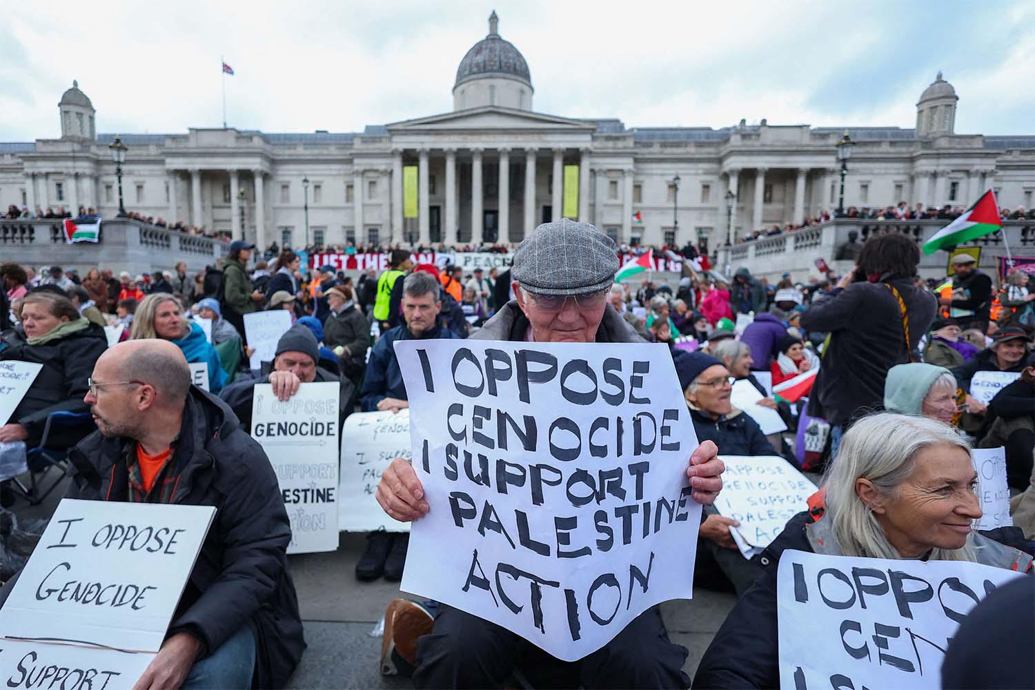 Protesters hold placards during a mass demonstration in London against the British governments ban on Palestine Action last October