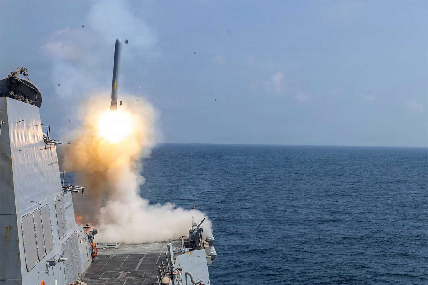 The US Navy Arleigh Burke-class guided-missile destroyer USS Delbert D. Black fires a Tomahawk Land Attack Missile (TLAM) in support of the Operation Epic Fury attack on Iran f