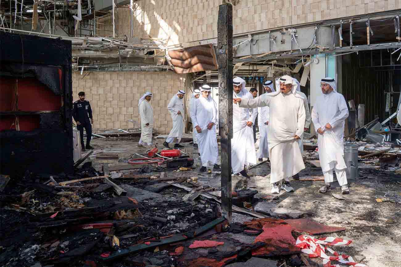 Kuwaiti officials inspect damage inside a terminal at Kuwait International Airport following an Iranian drone and missile attack