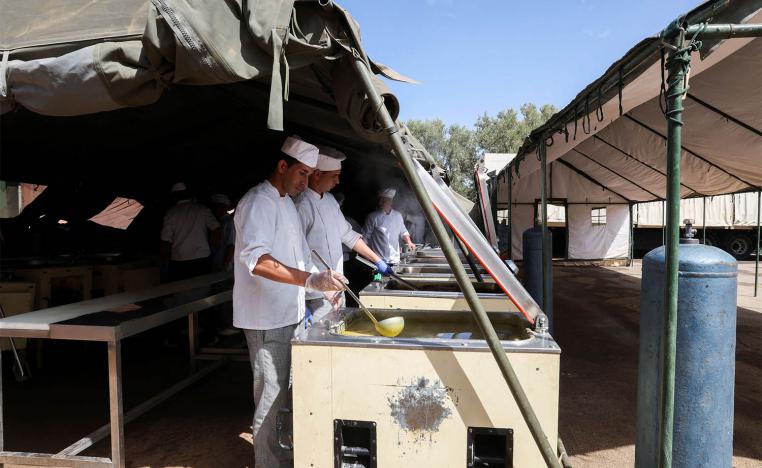 en prepare meals for displaced people residing in a military aid camp following the deadly earthquake in Amizmiz in September 2023